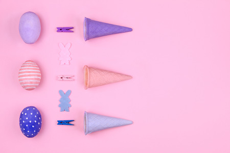 Happy Easter Day. Pink, blue and violet easter eggs, colorful clothespin, waffle cone and silhouette...