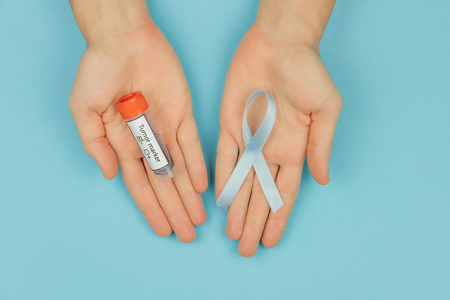 Man hands with cyan / blue tape as symbol of men's illness prostate cancer and negative blood test...