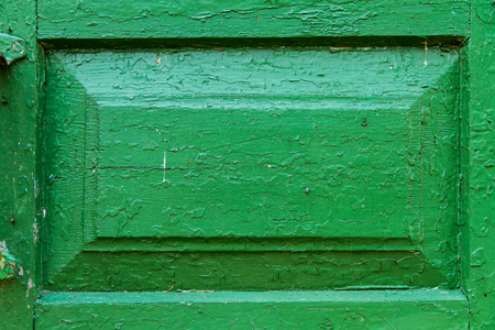 The decoration of wooden door texture with green paint is severely weathered and peelingの写真素材