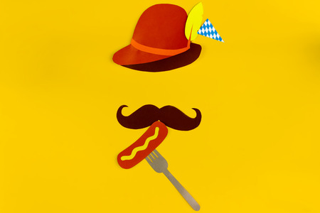 Germany face silhouette with bavarian brown hat, mustache eating sousage with mustard on fork. Ads event of october beer festival in autumn october monthの写真素材