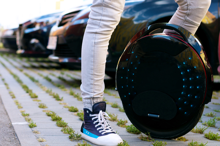 Future is now concept. Ecological transport. Black modern futuristic electric unicycle, unicycle...