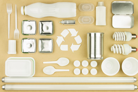 White recycling symbol sign in center  garbage trash plastic bottles, plastic disposable tableware: forks, spoons, containers and plates, metal cans and jars, cfl and tube light bulbs. Recycle conceptの写真素材