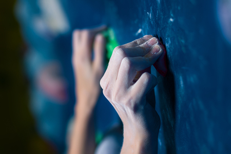 Hands of successful happy muscle healthy winner climber mountaineer alpinist female woman bouldering training in climbing wall in complex competition. Success healthy lifestyle, do not give up conceptの写真素材