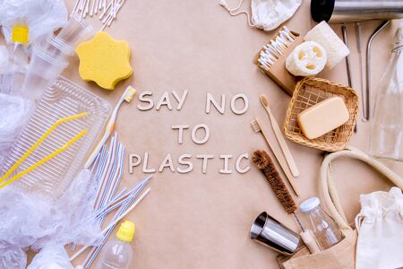 Bath accessories, care products, kitchenware, daily use subjects on craft paper background. On left side items in disposable package, on right reusable natural. Say no to plastic. Zero waste concept. の写真素材