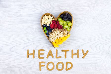 Raw healthy food: banana, berries: strawberry, blackberry, raspberry, grape with quinoa and cashew nuts for breakfast isolated on white background. Healthy, fitness, diet and raw food to go concept.の写真素材