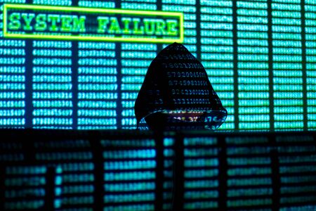Man in hood and mask is hacking password. Programmer is writing code on multiple screens to steal...