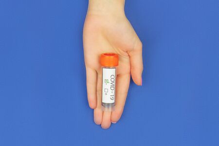 Closeup female hand is holding test tube with blood analysis. SARS-CoV-2, 2019-nCoV negative test....
