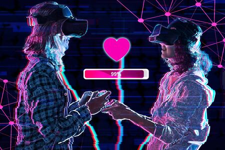 Couple are playing in virtual reality club. Young woman and man in VR glasses are gaming with holograms using joysticks. Entertainment and leisure concept. Adult simulation games. Modern technologies.の写真素材