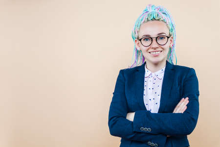 Positive modern business lady with colored dreadlocks is smiling. Young woman, leader, trainer,...