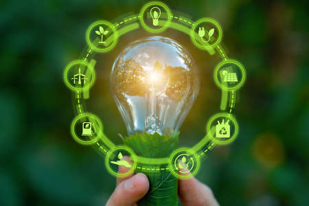 Green energy innovation light bulb with future industry of power generation icon graphic interface. Concept of sustainability development by alternative sources renewable. Ecology and environment.の写真素材