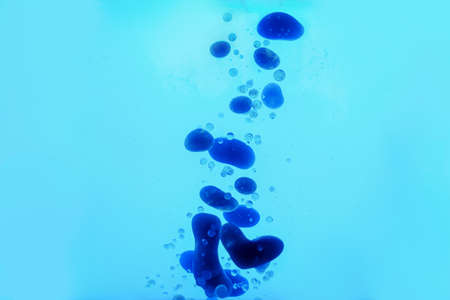Beautiful colorful background with glitter and blue colored oil bubbles and watercolor. Sparkle...