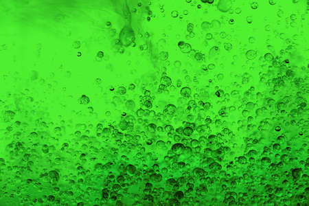 Beautiful colorful background with glitter and colored bubbles in oil and watercolor. Sparkle particles. Macro oil ink bubbles and drops. Abstract template mixed texture. Colored wallpaper pattern.の写真素材