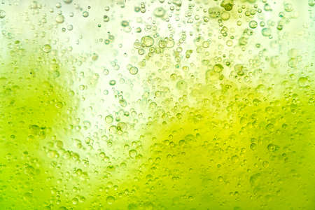 Fantastic structure of colorful oil bubbles. Chaotic motion. Abstract paint. Flat lay. Movement of bubbles in the liquid. Water surface multicolored background. Macro pattern, design mockup.の写真素材