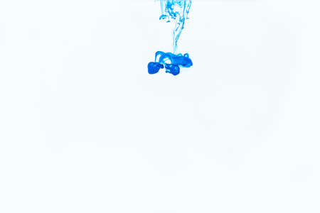 Blue watercolor ink in water shot with high speed camera and flowing downward. Paint movement macro....