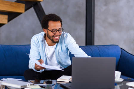 Skilled african man freelancer sit in comfortable pose work from home consult client by video link...