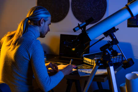 Astronomer man do astronomy work. Telescope pointing on the night sky, space, cosmos, universe, Milky way. Male scientist watching the stars and Moon with professional telescope at a summer day.の写真素材