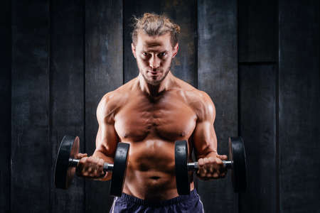 Fitness in gym, sport and healthy lifestyle concept. Handsome athletic man with naked torso making...