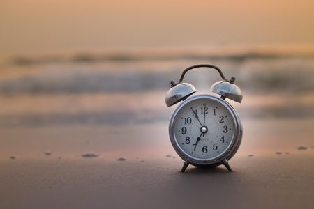Concept alarm clock on beach still life Retroの写真素材