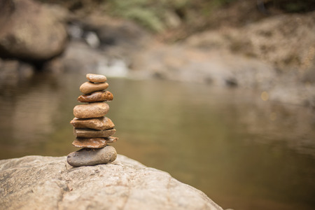 Rock Zen Stack in front of waterfallの写真素材