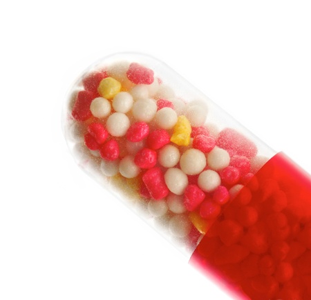 macro closeup of red pill isolated on whiteの写真素材