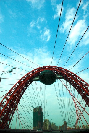 Red modern suspension bridge. Zhivopisny bridge in Moscow, Russiaの写真素材