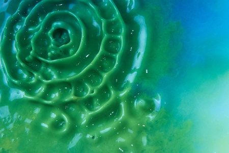 Abstract background formed by mixed blue and yellow paintの写真素材