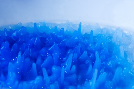 Abstract background formed by mixing blue paintの写真素材
