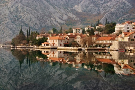 waterscape with old town against mountain and perfect  mirror imageの写真素材