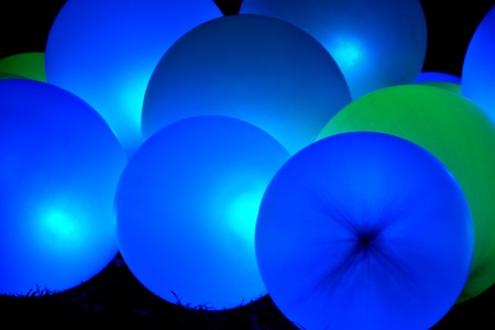 Background of glowing green and blue inflatable balloonsの写真素材