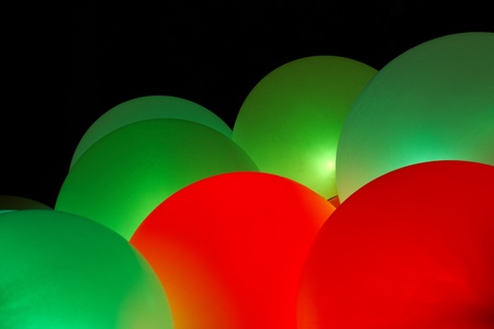 Background of glowing green and red inflatable balloonsの写真素材