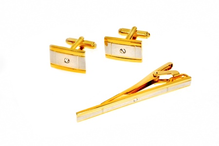 golden cuff link and tie pin isolated on white backgroundの写真素材