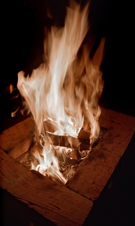 Burning campfire enclosed  with blocks on black background