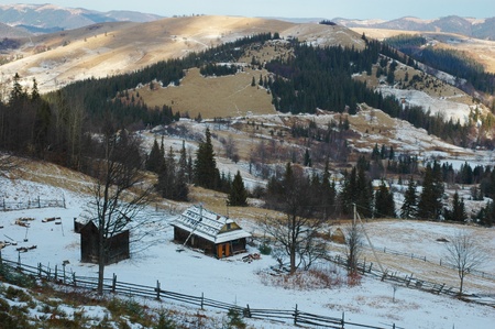 View of village in mountains on cloudy winter dayの写真素材