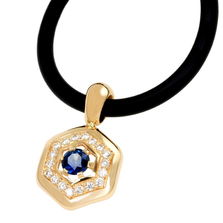 golden pendant with sapphire and diamonds isolated on whiteの写真素材