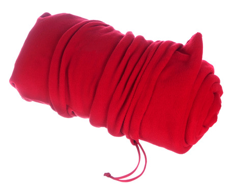 Rolled red blanket in bag isolated on whiteの写真素材