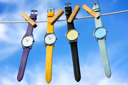 composition of colourful watches on blue sky backgroundの写真素材