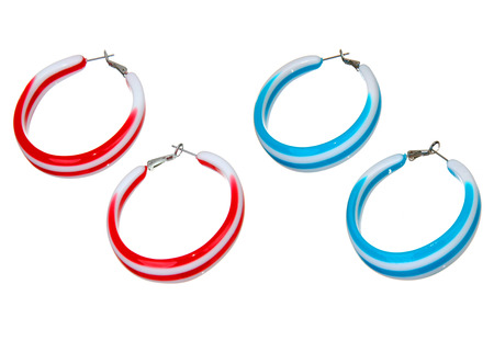 blue and red plastic earrings isolated on whiteの写真素材
