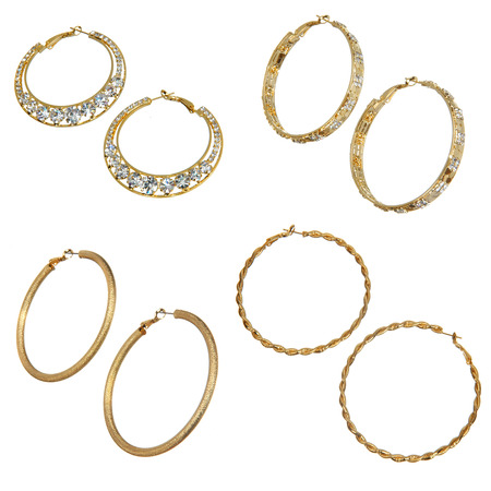 set of round golden earrings isolated on whiteの写真素材