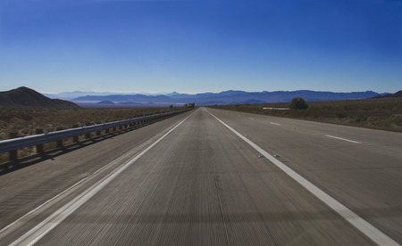 asphalt road towards the mountainの写真素材