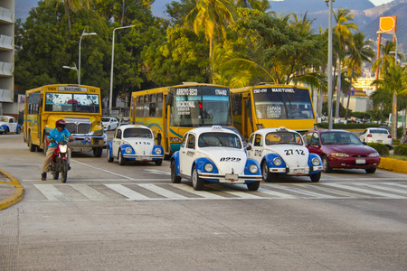 busy street with taxis and buses in acapulcoのeditorial素材