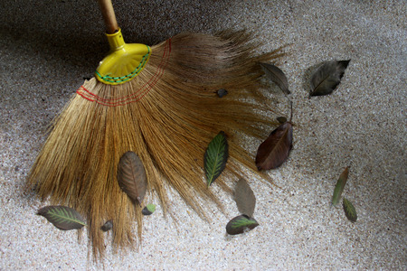Garden broom and dry leavesの写真素材