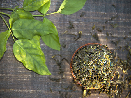 dry green tea on wooden backgroundの写真素材