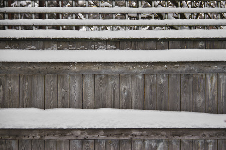 wooden fence covered with snowの写真素材