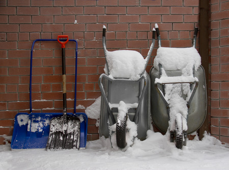 snow showels and wheelbarrows in winder yardの写真素材