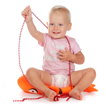 little blonde girl playing on the floor isolated on whiteの写真素材