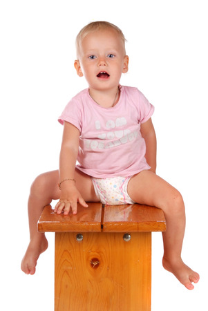 portrait of a little girl sitting on a stoolの写真素材