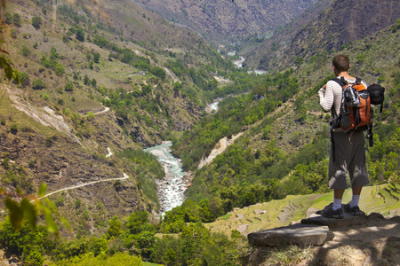 hiker stands on the hill enjoying the viewの写真素材
