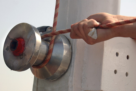 Hand holding rope on the winch