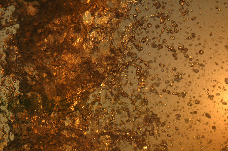 big water splashes in front of bright skyの写真素材