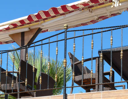 Open terrace for relaxation with a canopy and wicker chairs and tablesの写真素材